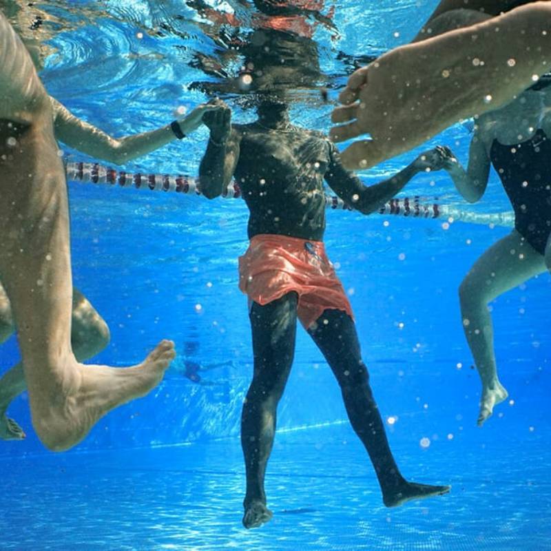 models underwater in swimming pool wearing nike swim swimming shorts