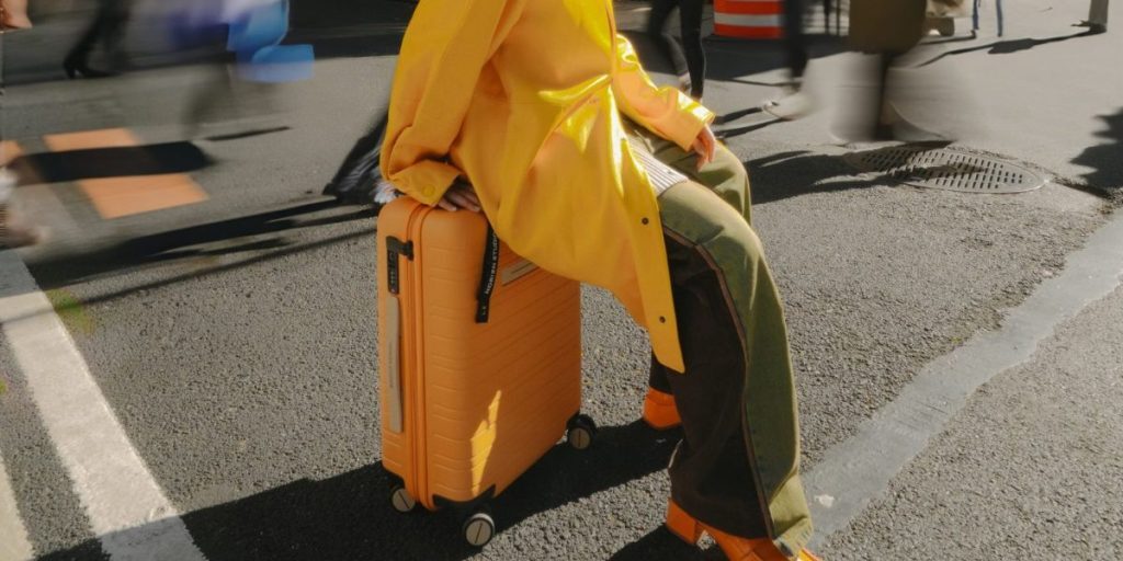 woman sitting on suitcase