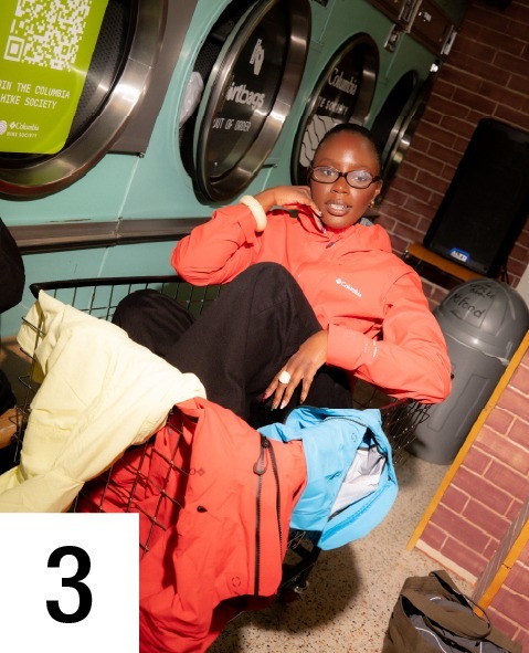 Step 3, Influencer strategy: a person sitting in a launderette surrounded by outdoor jackets