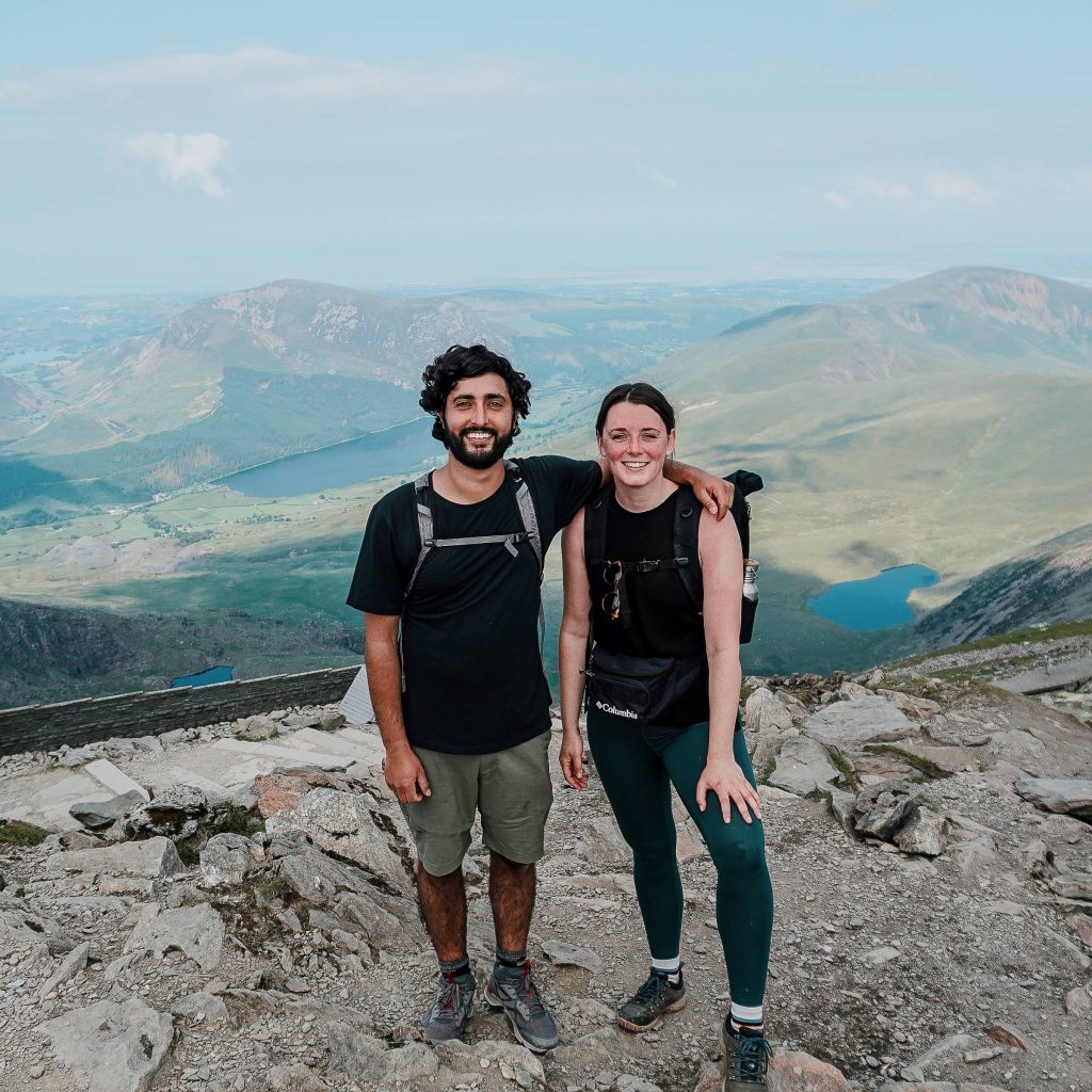 couple posing on top of hill wearing columbia sportswear clothes