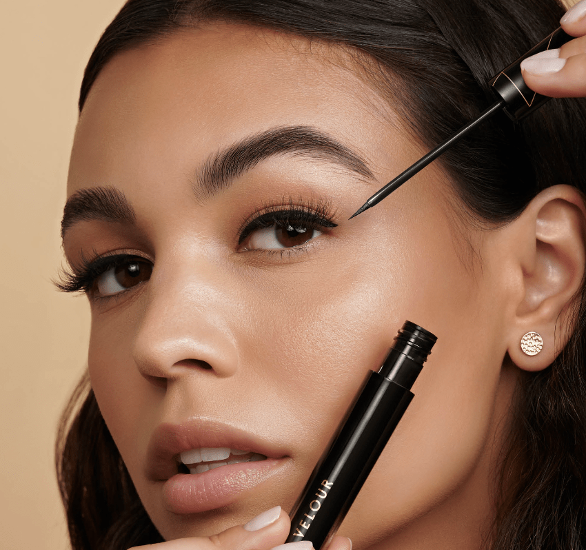 female model applying velour eyelash cream