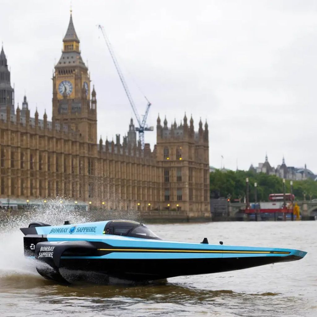 A Bombay Sapphire branded RaceBird on the River Thames in London for the E1 London Showrun with the Houses of Parliament in the background.