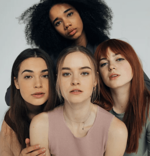 four women looking at camera