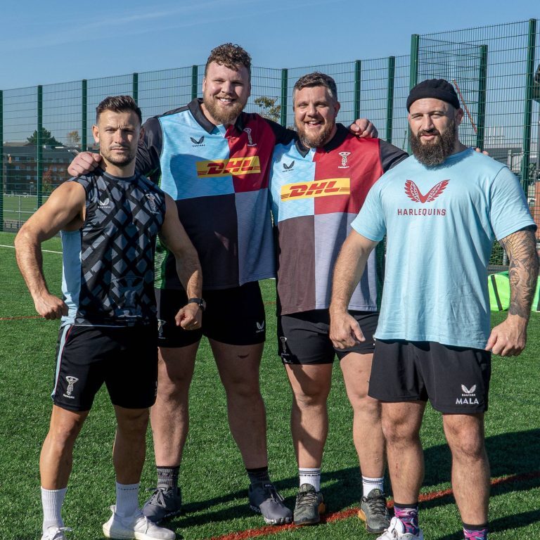 thomas stoltman and two rugby players at reign energy event