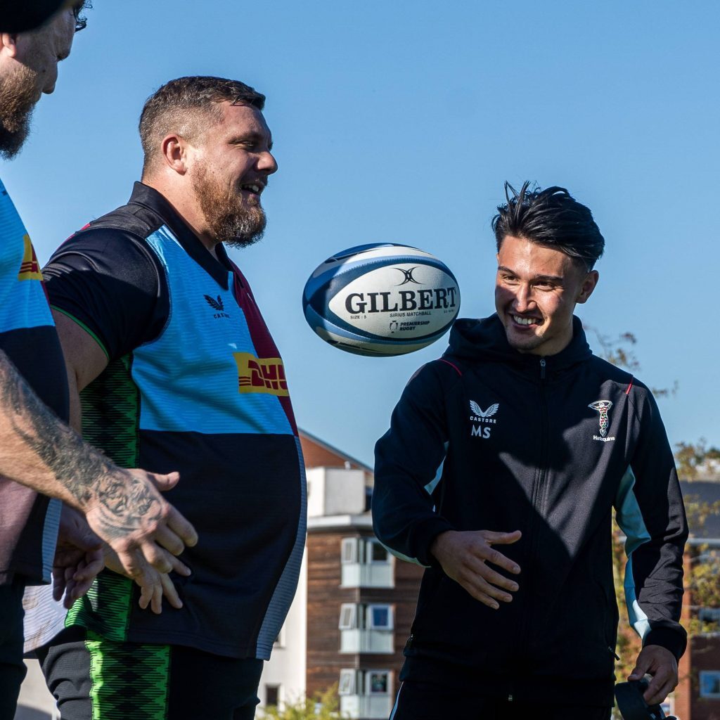 stoltman brother with rugby ball and harlequins players