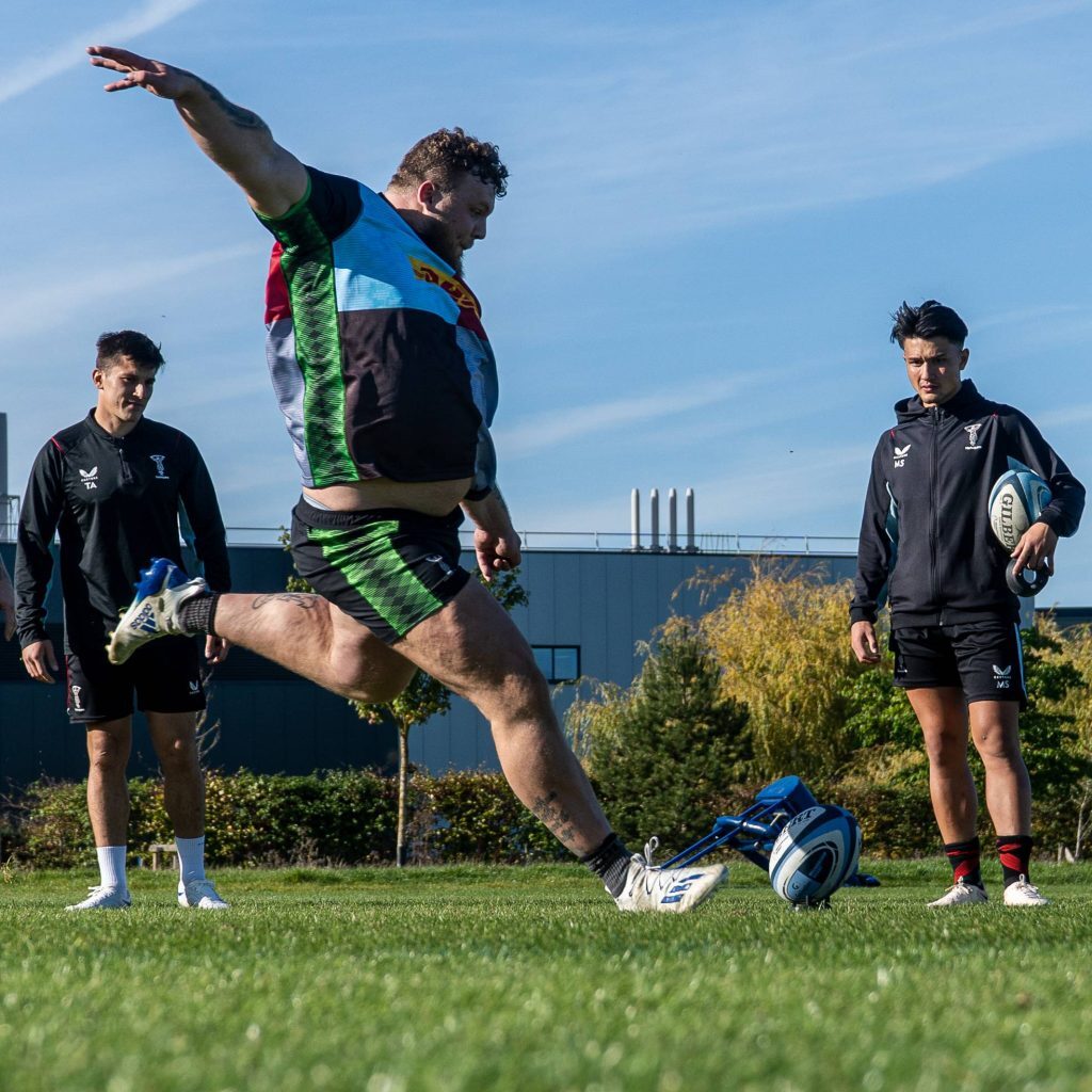 a stoltman brother kicking a rugby ball