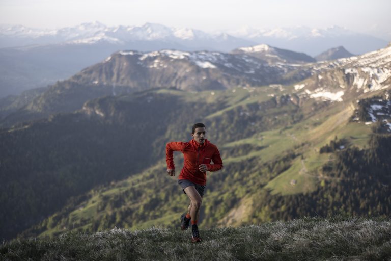 woman running up a hill in merrell jacket