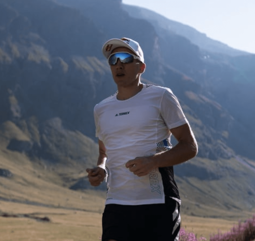 man running in countryside wearing sungod sunglasses