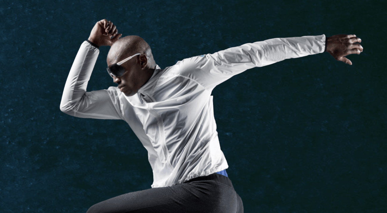 man with goggles running in the air wearing uyn