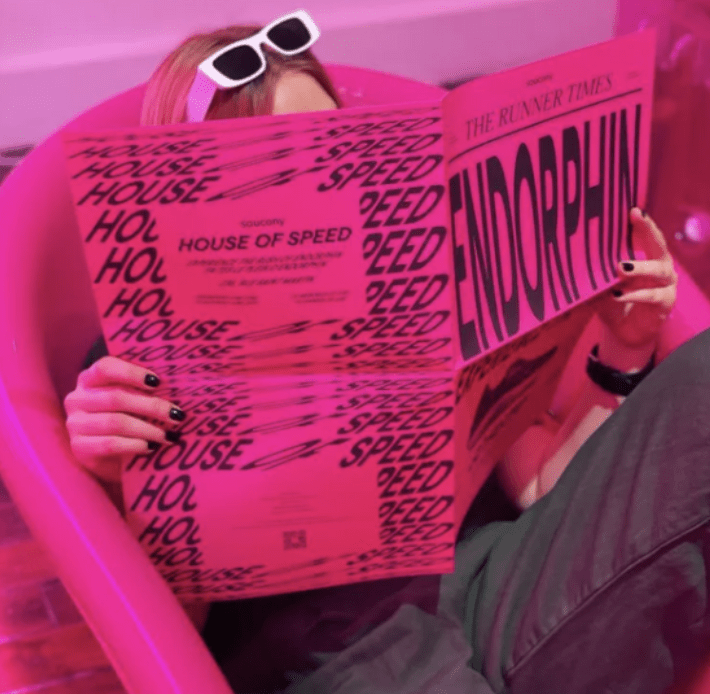 woman reading saucony endorphin magazine