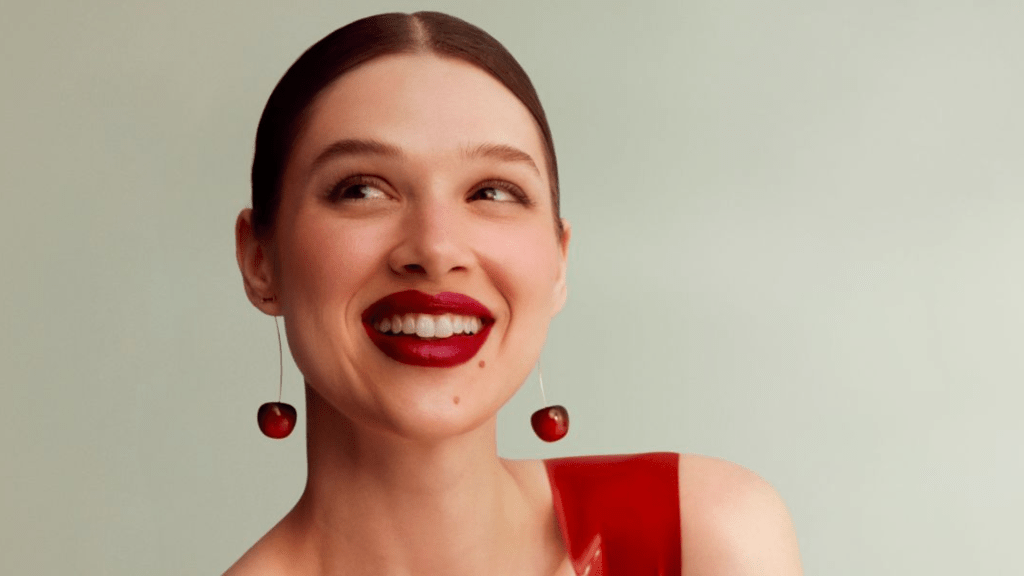 woman smiling with cherry earrings