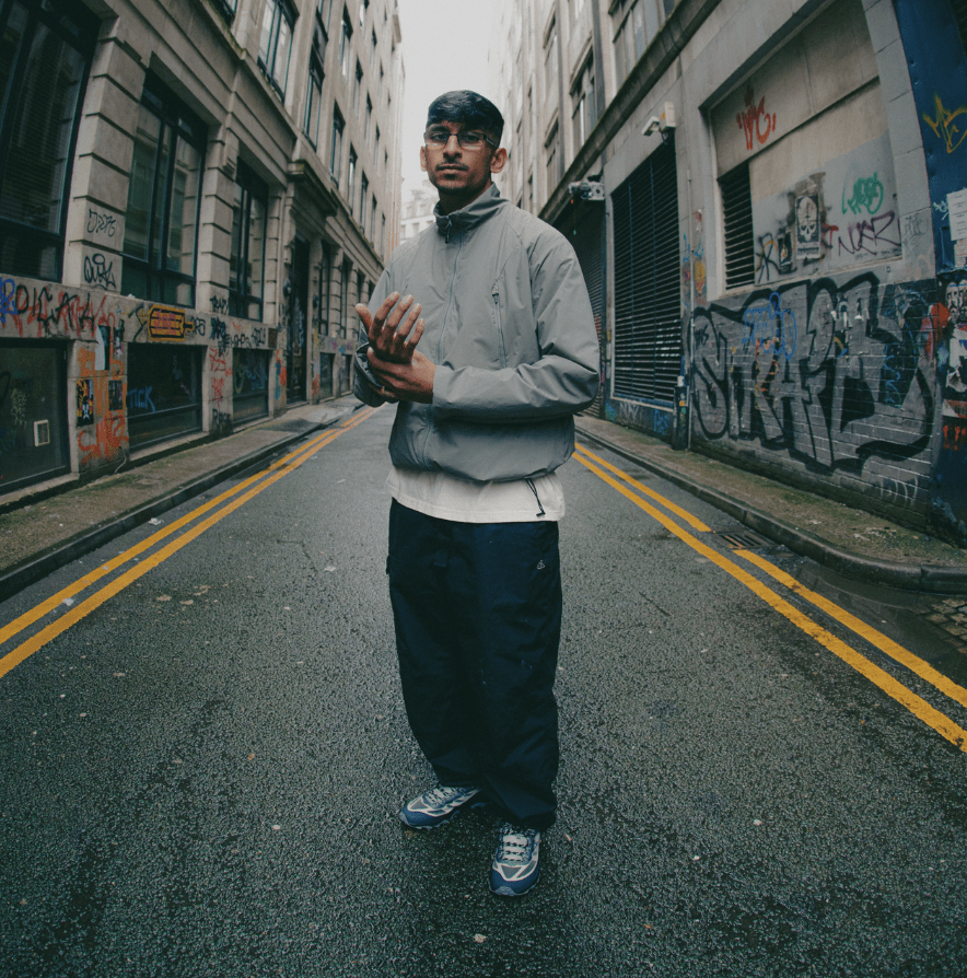 man wearing merrell trainers in middle of road