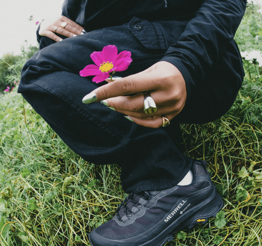 woman in merrell trainers holding pink pettle