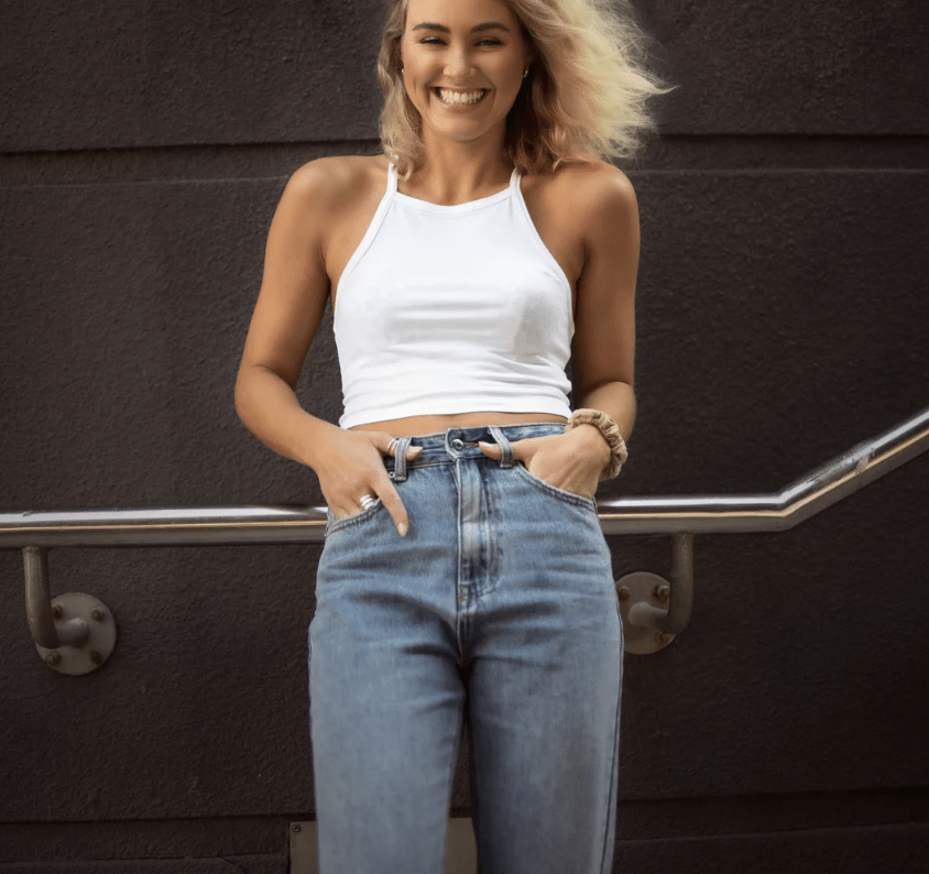 female model smiling with hands in pockets