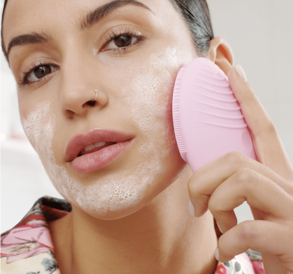 model using foreo on their cheek