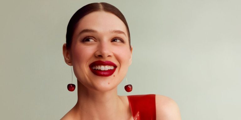 Woman smiling with cherry earrings