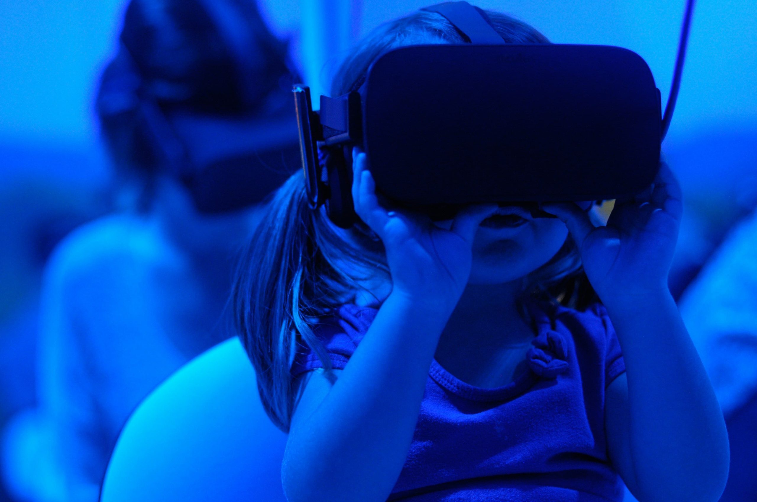 a young girl wearing a VR headset