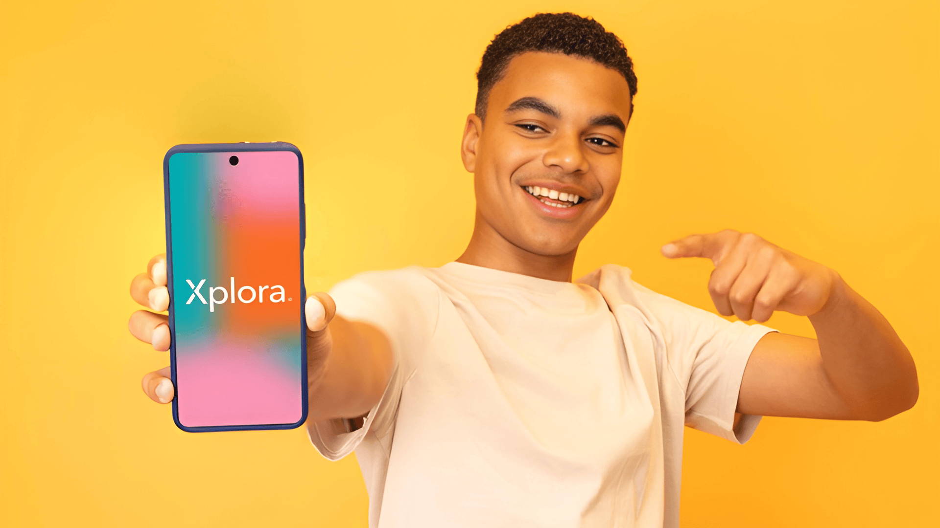 boy holds phone showing xplora logo on screen