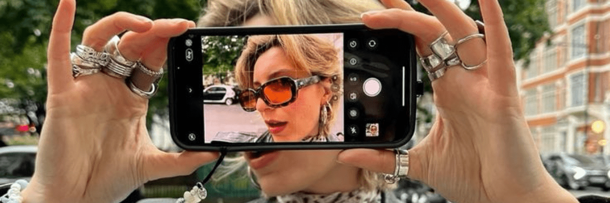 a photo of a woman holding a phone taking a photo of herself