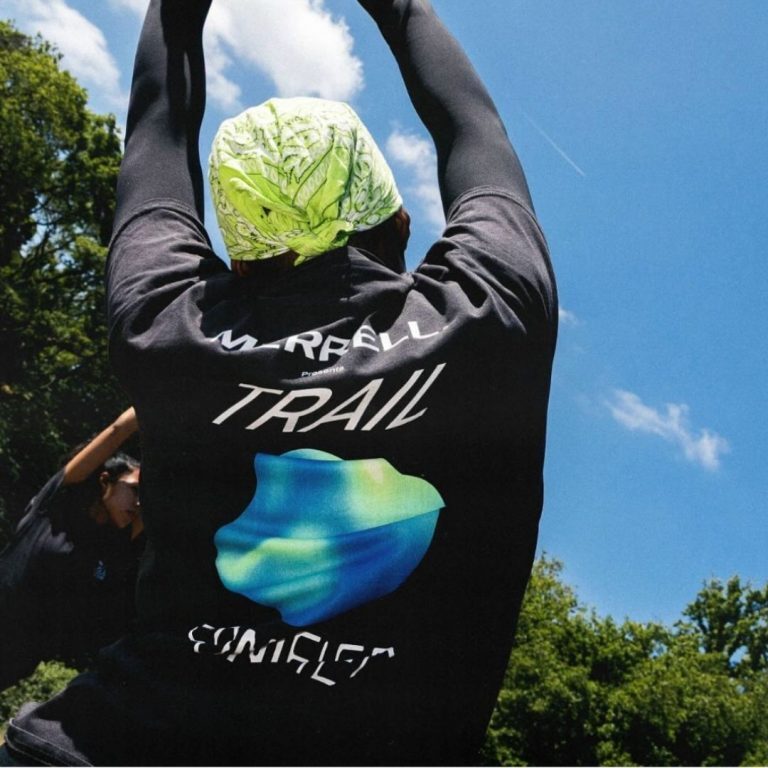 man stretching wearing merrell trail sonified t-shirt