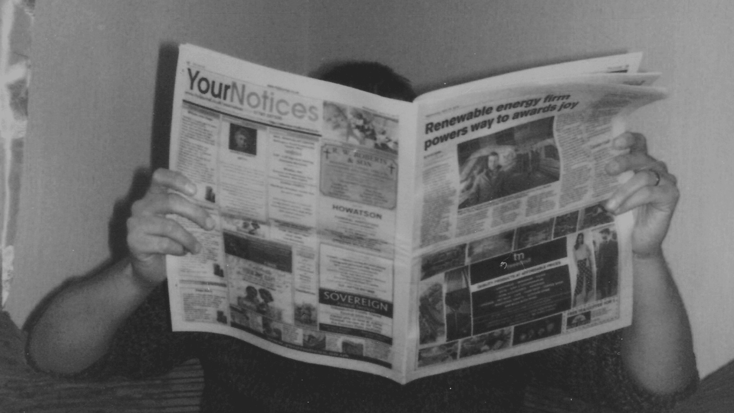 Person holding a newspaper