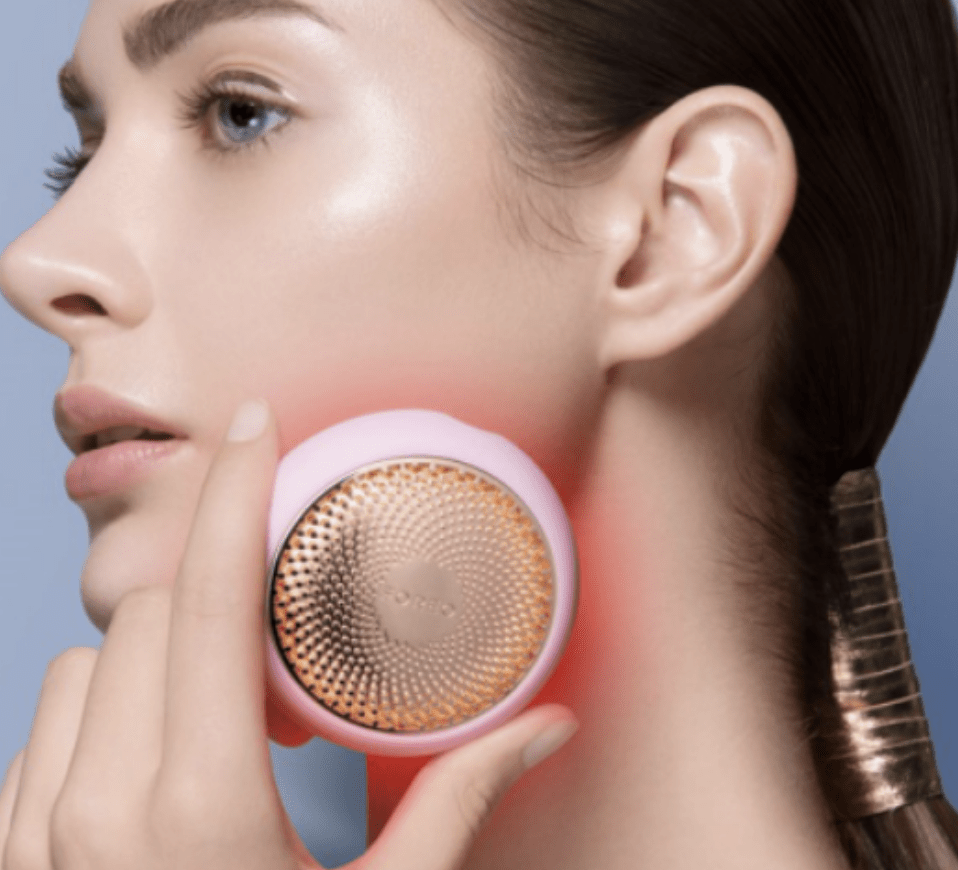 female model using foreo on their cheek