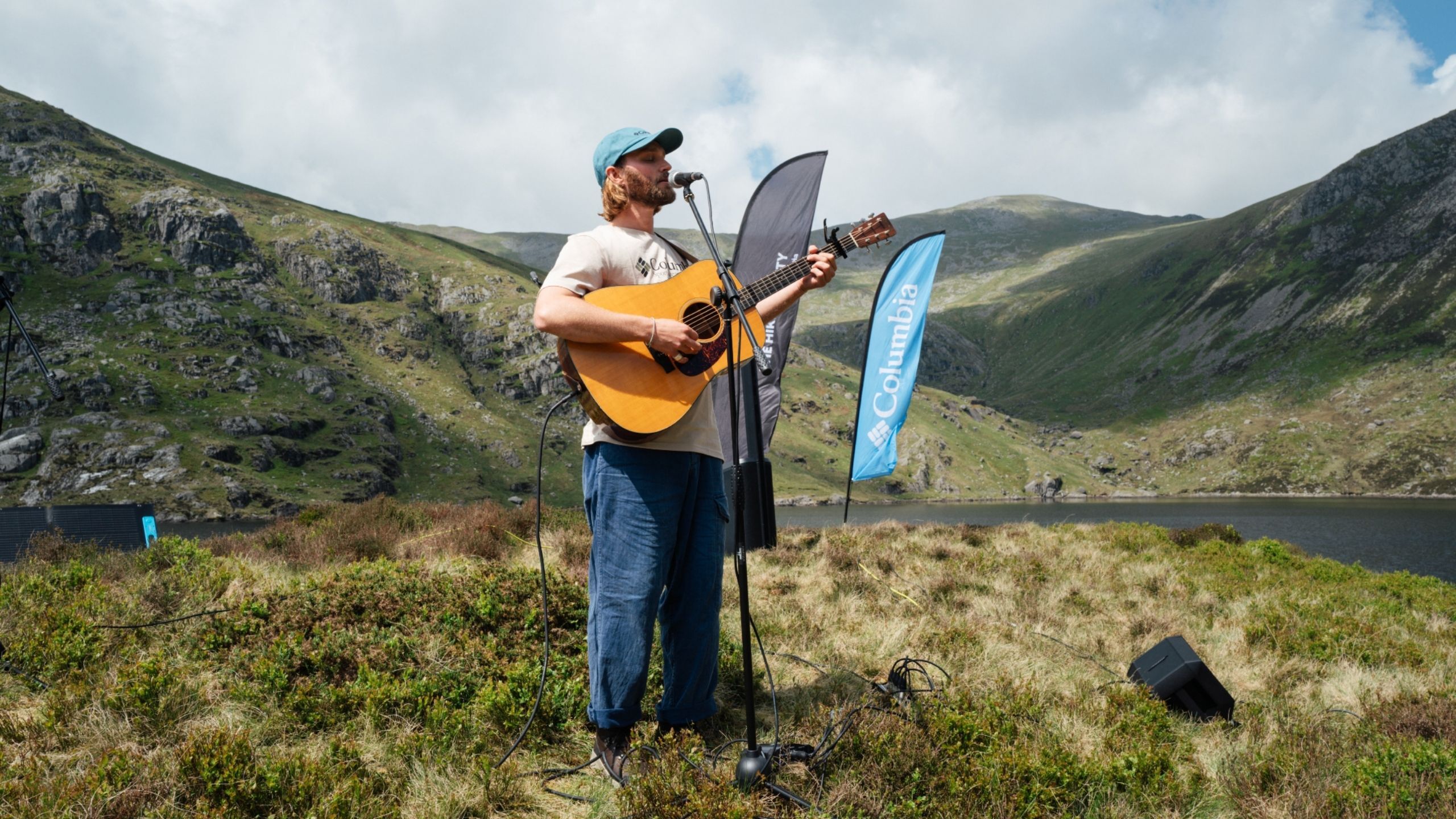 man playing guitar in mountain landscape