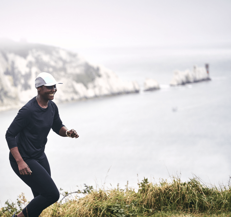 female running on hill b the beach