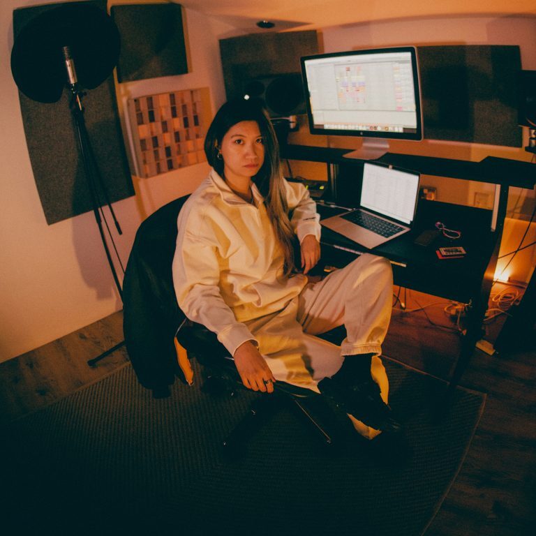 woman dj in merrell mountain radio trainers sitting by desk