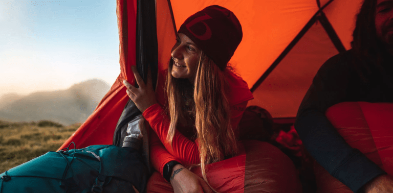 woman looking out of rab equipment tent